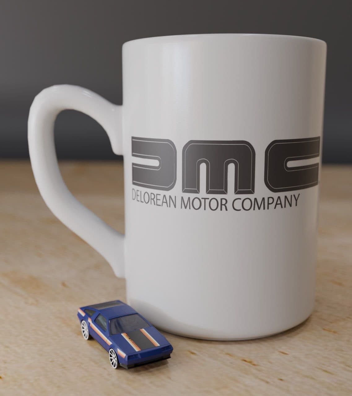 White DMC DeLorean Motor Company mug with a miniature blue DeLorean car in front.
