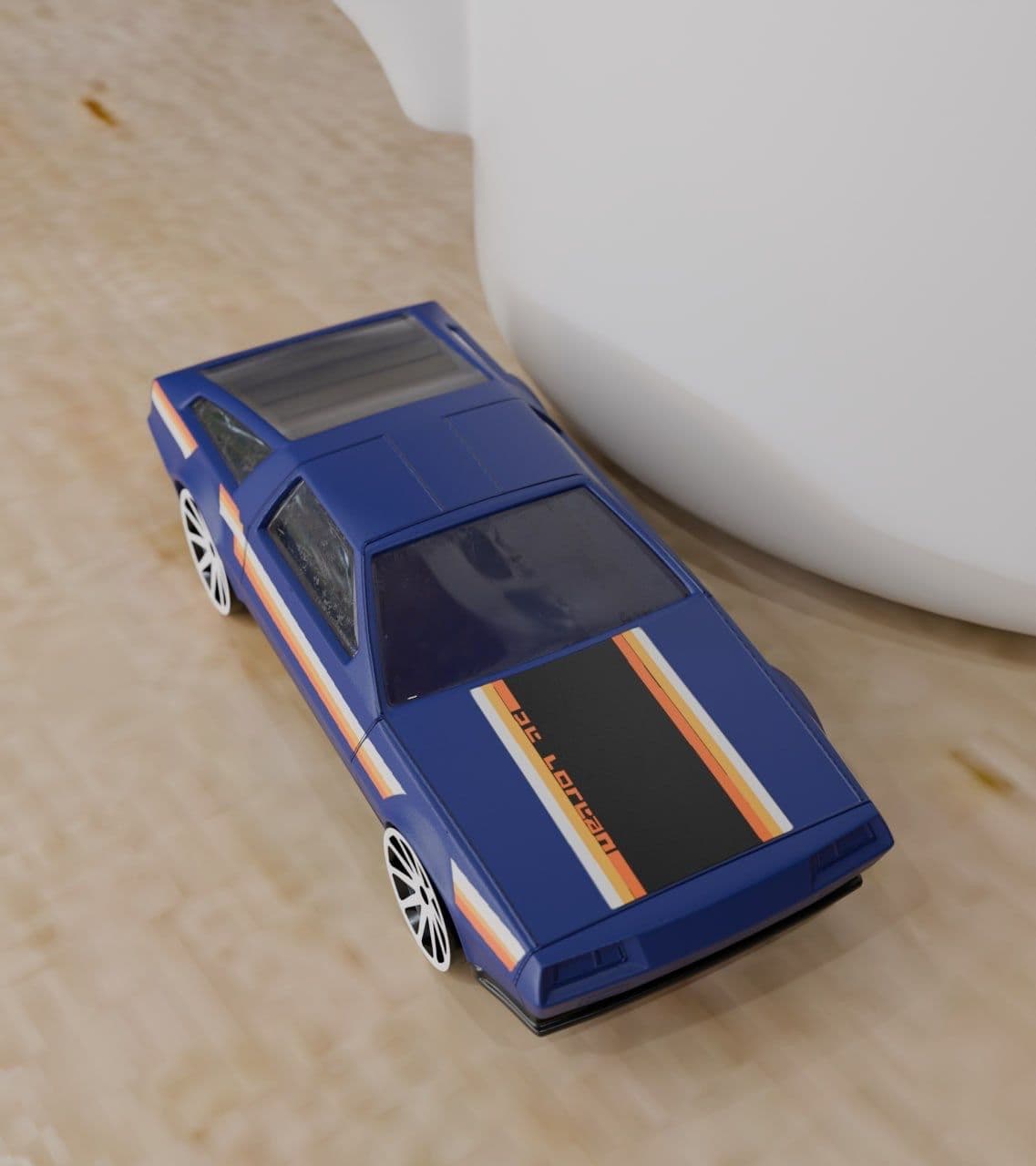 A blue toy car with black and orange racing stripes on the hood sits on a wooden surface.